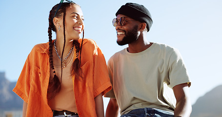 Image showing Peace, love and couple in the city to relax, smile and be happy together in summer. Portrait of an urban and interracial man and woman with hand sign for communication and comedy against a blue sky