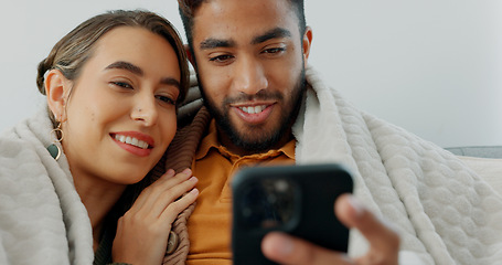 Image showing Happy, couple with phone for communication, networking or social media app at home. Movie, video or love man and woman relax in living room streaming online, internet or website with smile in house