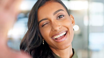 Image showing Smiling, beautiful and fresh female face winking feeling fun, silly and playful. Portrait of a happy woman head with perfect skin and healthy teeth. Closeup of a carefree natural beauty with a smile