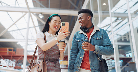 Image showing Shopping mall, smartphone and couple of friends on social media, website or blog for discount, sales and travel communication. Diversity gen z people walking, using phone or cellphone and coffee cup