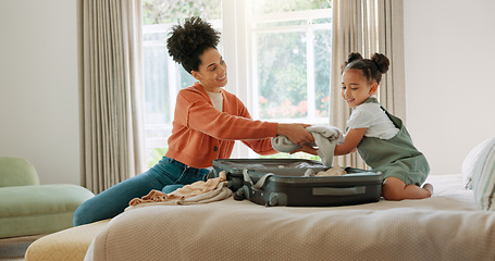 Image showing Travel, luggage and mom packing with child in bedroom getting ready for trip. Helping hands, black family and young girl help mother pack clothes in suitcase for holiday, vacation and weekend away