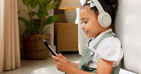 Image showing Tablet game, headphones and relax child gaming, having fun or play online games on mobile device or digital tech app. Kid entertainment, youth lifestyle and young gamer girl playing on ui touchscreen