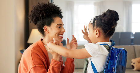 Image showing Little girl kissing her mother. Young mother hugging her daughter. Loving mother hugging daughter before school outside. Little girl going to school. Happy woman embracing daughter