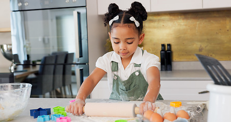 Image showing Happy girl kids baking cookies with rolling pin in kitchen, house and home for childhood fun, learning and development. Young toddler child playing little cooking chef, baker and sweets dessert dough