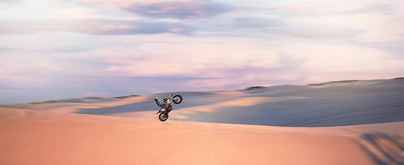 Image showing Desert dunes, moto cross and sports adventure athlete doing a extreme jump with speed. Travel, sand and bike with energy of a man athlete cycling on dirt with challenge and sport race with freedom