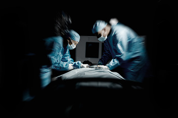 Image showing Doctors, night surgery and hospital theater with patient and surgeon team for emergency, teamwork and trust. Medical man and woman in dark for life saving, healthcare and health insurance emergency