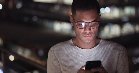 Image showing Business man, phone and night data while online on an urban building rooftop typing email, search or communication for networking on trading app. Entrepreneur on terrace in dark with 5g network