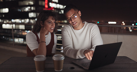 Image showing Laptop, collaboration and night with a business team working together on balcony in the city. Teamwork, computer and overtime with a man and woman employee at work late on a project deadline