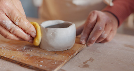 Image showing Hands, pottery clay or wet sponge for creative sculpture, product manufacturing or mud mold in art studio, small business or startup. Zoom, man or ceramic artist in workshop design process with water