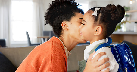 Image showing Little girl kissing her mother. Young mother hugging her daughter. Loving mother hugging daughter before school outside. Little girl going to school. Happy woman embracing daughter