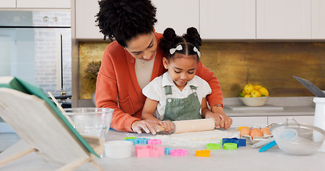 Image showing Mother, girl learning baking in kitchen and rolling flower dough on counter to cook cookies for fun, learning and development. Happy mom, black child with smile and teaching daughter to bake together