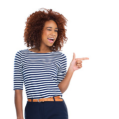 Image showing Woman portrait, wink and pointing at promotion, isolated advertising space and product placement marketing. Smile, happy or excited model in showing hands gesture for sales mockup on white background