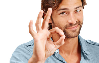 Image showing Man, face and OK with hand in portrait, agreement or good review, feedback and emoji sign against studio background. Yes gesture, success and vote with approval and male voice positive opinion