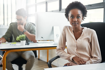 Image showing Creative, black woman and office portrait at desk, sitting or focus with business people at web design agency. Webdesign woman, success and vision at table by corporate background for career goal