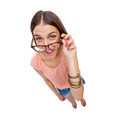 Image showing Woman, comedy and portrait of a model with glasses, smile and casual fashion being silly. White background, happiness and isolated young person looking up in a studio feeling positive, comic and fun