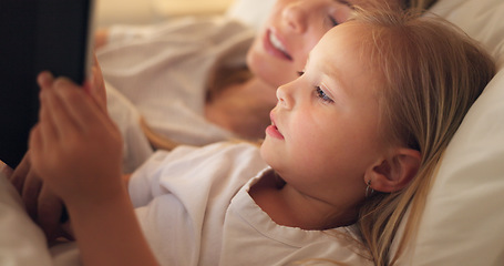 Image showing Tablet, mother and child on the internet in bed, streaming a movie or reading a book on the web at night. Education, learning and games on technology for a girl and her mom together in the bedroom