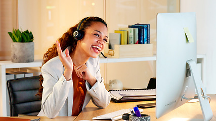 Image showing A happy modern business woman having an online meeting at her computer. A cheerful worker talking during a corporate teamwork seminar. A female accountant on a company web conference at her desk.
