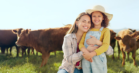 Image showing Farming, child and mother with kiss on a farm during holiday in Spain for sustainability with cattle. Portrait of happy, smile and travel mom and girl with love while on vacation on land with cows