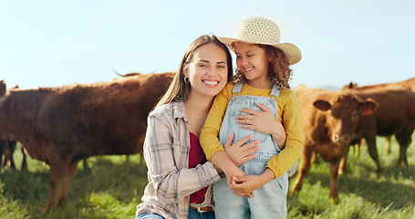 Image showing Farming, child and mother with kiss on a farm during holiday in Spain for sustainability with cattle. Portrait of happy, smile and travel mom and girl with love while on vacation on land with cows