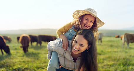 Image showing Family, farm and fun with a girl and mother playing on a grass meadow or field with cattle in the background. Agriculture, sustainability and love with a woman and her daughter enjoying time together