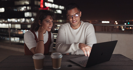 Image showing Laptop, collaboration and night with a business team working together on balcony in the city. Teamwork, computer and overtime with a man and woman employee at work late on a project deadline