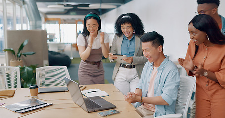 Image showing Winner, yes and applause with a business asian man cheering with his team while working on a laptop on his office. Goal, wow and success with a male employee and colleague group in celebration