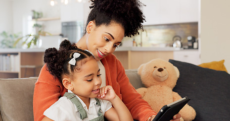 Image showing Mother, girl with tablet and learning on sofa at home for development, bonding and education with digital technology. Happy mom, kid smile together and bonding of living room couch in a family house