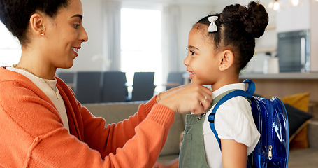 Image showing Little girl kissing her mother. Young mother hugging her daughter. Loving mother hugging daughter before school outside. Little girl going to school. Happy woman embracing daughter