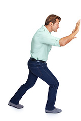 Image showing Man, pushing and obstacle or frame in struggle against a white studio background. Isolated casual male walking to push heavy weight or shield using physical effort with expression or gesture