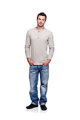 Image showing Fashion, style and portrait of man on a white background posing in trendy, stylish and modern clothes. 2000s style, confident and fashion model isolated in studio with casual, retro and cool clothes