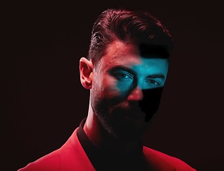 Image showing Art, neon and creative portrait of man with light reflection in eyes on serious face with self expression. Futuristic fashion, male model and beauty with red and blue studio lights on dark background