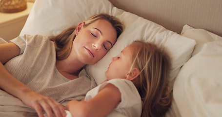 Image showing Bed, mom and child relax sleep together in bed, calm and peace in bedroom at night in home. Tired young mother, kid girl sleeping and childhood support, trust and care in safe peaceful family house
