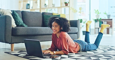 Image showing Music, laptop and relax girl on floor carpet streaming radio rap, disco or rock song while singing trendy audio. Headphones, energy or student black woman listening to wellness sound and typing on pc