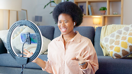 Image showing Beauty influencer filming a makeup tutorial at home. Young female blogger live streaming a broadcast online with ring light for a vlog channel. Recording a fun podcast for followers on social media