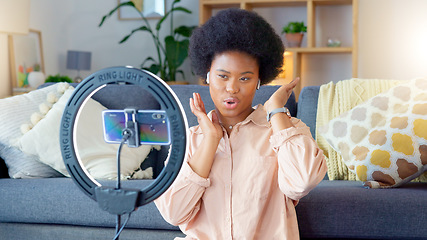 Image showing Female influencer and vlogger recording content on a phone at home. Young creator live streaming online for a vlog channel. Filming a podcast while speaking to followers and viewers on social media