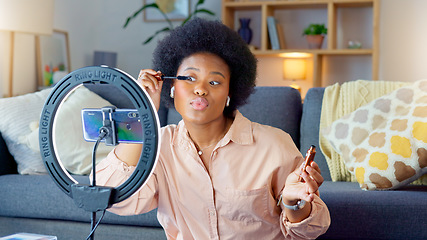 Image showing Afro beauty influencer, vlogger or podcast host talking, using phone to film live stream makeup tutorial with new mascara makeup. Excited woman using technology to promote cosmetic product from home