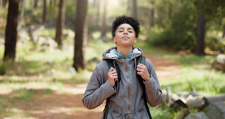 Image showing Hiking, thinking and adventure with a black woman in nature, sightseeing while walking on a trail outdoor. Freedom, travel and health with a young female hiker out for discovery and exploration