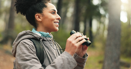 Image showing Hiking, forest and woman with binocular watch nature scenery, view or bird watching while trekking through trees. Adventure woods, travel journey or Brazil black girl backpacking in Amazon Rainforest