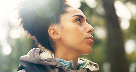 Image showing Hiking, thinking and adventure with a black woman in nature, sightseeing while walking on a trail outdoor. Freedom, travel and health with a young female hiker out for discovery and exploration