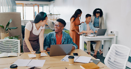 Image showing Teamwork, laptop and business people fist bump in office for success celebration. Training, coaching and Asian woman teaching black man, support and advice while celebrating after solving problem.