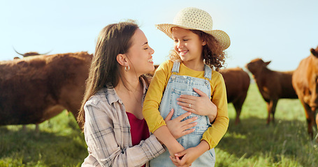 Image showing Farming, child and mother with kiss on a farm during holiday in Spain for sustainability with cattle. Portrait of happy, smile and travel mom and girl with love while on vacation on land with cows