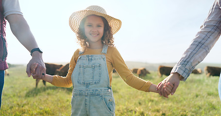 Image showing Farmer, family and girl with parents at cattle farm, holding hands and learning about livestock, family business and sustainable living. Love, agriculture and happy family bonding in nature with cows