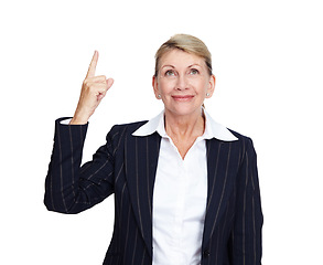 Image showing Senior business woman, smile and pointing finger up in white background for suggestions, product placement and mockup. Elderly person, happy face and corporate manager hand gesture isolated in studio