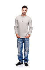 Image showing Portrait, smile and man with hands in pocket in studio isolated on a white background looking happy. Pride, cool and model male posing in denim jeans clothes for trendy style and positive mindset