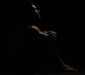 Image showing Man, silhouette and black background in a dark studio for depression, mental healthy and anxiety. Model person naked while lonely and thinking about stress, fail or erectile dysfunction problem