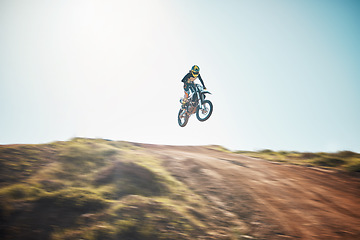 Image showing Motorbike, cycling and jump on blue sky mockup for speed challenge, sports and fearless athlete. Driver, air stunt and driving over hill with adrenaline, competition adventure and motorcycle power
