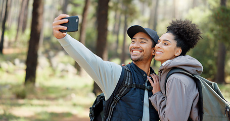 Image showing Hiking, selfie and young couple in forest smiling, happy and enjoy nature together. Fitness, wellness and Asian man with black woman taking picture with phone on adventure, trekking and walk in woods