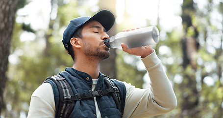 Image showing Water, drink and man with fitness hiking, exercise and thirsty in forest, nature and woods. Motivation, health and training with man hydrate after hike in nature environment for health, and wellness