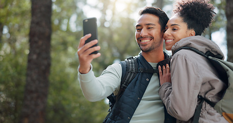 Image showing Hiking, selfie and young couple in forest smiling, happy and enjoy nature together. Fitness, wellness and Asian man with black woman taking picture with phone on adventure, trekking and walk in woods