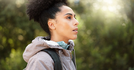 Image showing Hiking, thinking and adventure with a black woman in nature, sightseeing while walking on a trail outdoor. Freedom, travel and health with a young female hiker out for discovery and exploration